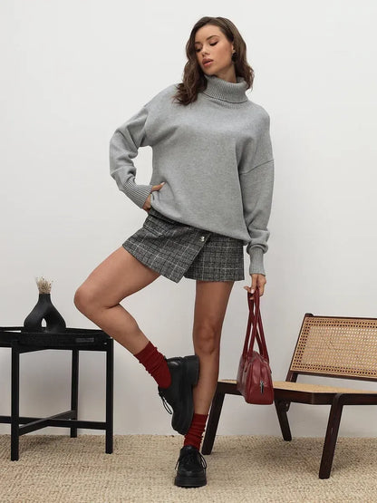 Lyra Sweater by Lauven in light grey worn with a skirt, showcasing cozy sophistication and relaxed minimalism.