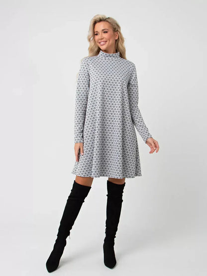 Model wearing the Maia Mini Dress by Lauven, a graphite grey A-line dress with long sleeves and stand collar.