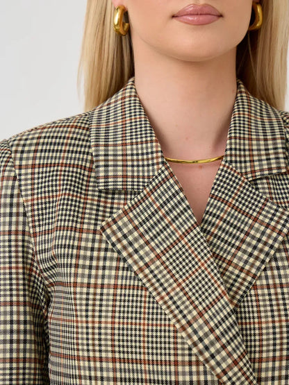 Close-up of the Maple Blazer by Lauven featuring a brown checked pattern and structured collar detail.