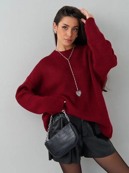 Maribel Sweater by Lauven in oversized burgundy knit, styled with a trendy black bag and chic outfit.