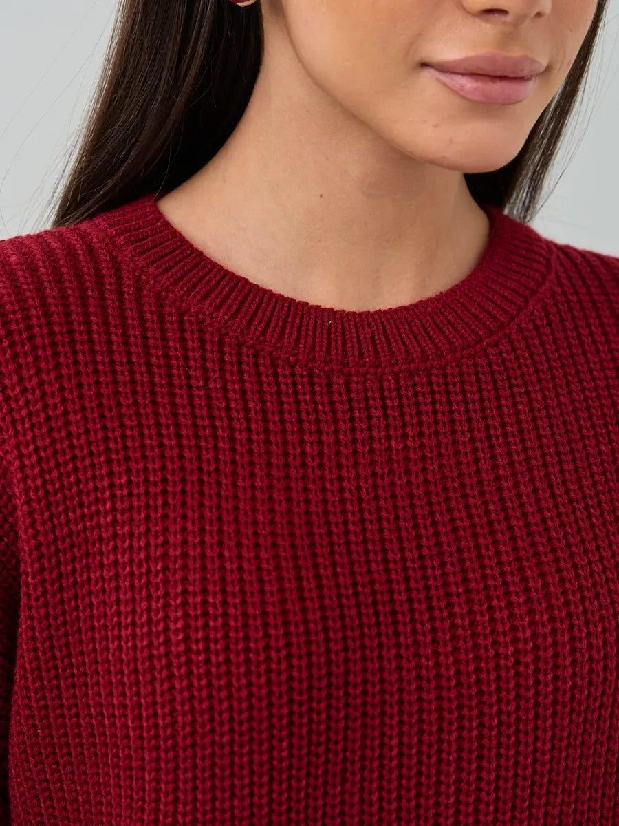 Close-up of the Maribel Sweater by Lauven, showcasing its oversized burgundy knit and crew neck design.