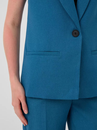 Marine Suit Set by Lauven featuring a sleeveless teal vest with button and pockets, showcasing modern fashion.