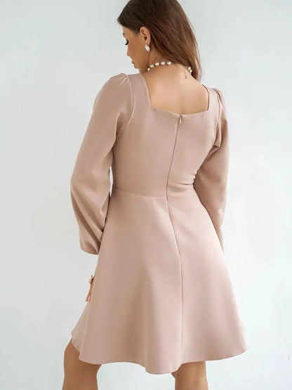 Milanese Mini Dress by Lauven in blush pink with long sleeves and A-line skirt, showcasing a structured bodice and square neckline.