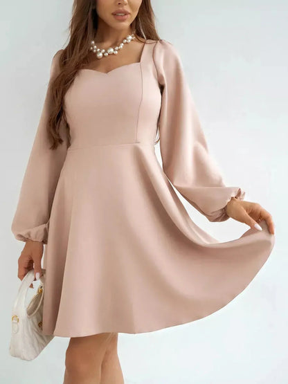 Milanese Mini Dress by Lauven in blush pink, long sleeve A-line style with structured bodice and gathered shoulders.