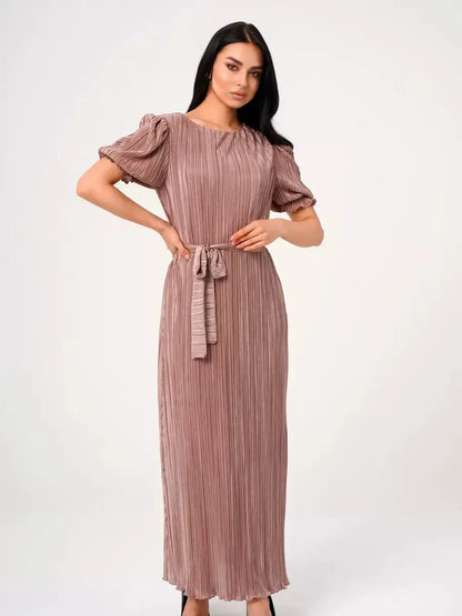 Noa Maxi Dress featuring elegant pleats, puff sleeves, and a soft cappuccino hue for modern occasionwear.