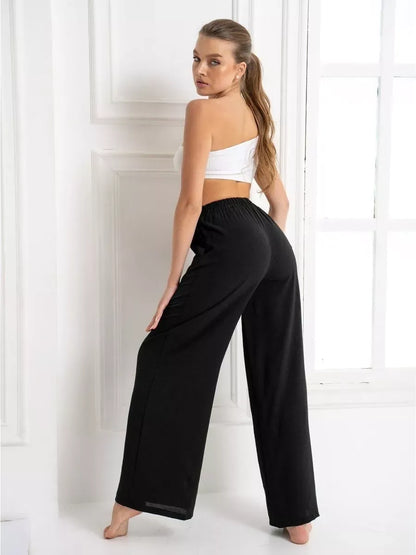 Model wearing wide-leg trousers from Lauven's Noir Suit Set, showcasing timeless elegance and modern sophistication.
