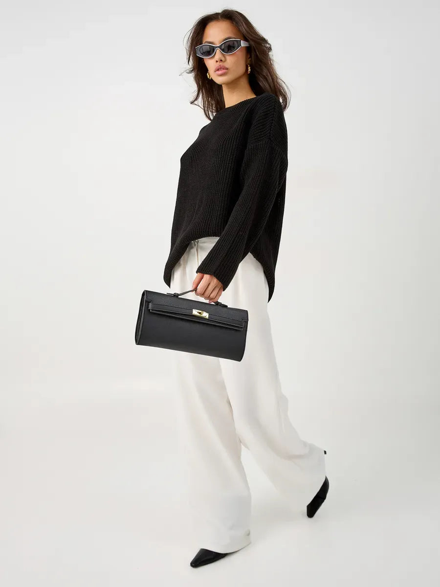 Nola Sweater by Lauven - Oversized black knit with crew neck, styled with white pants and handbag.