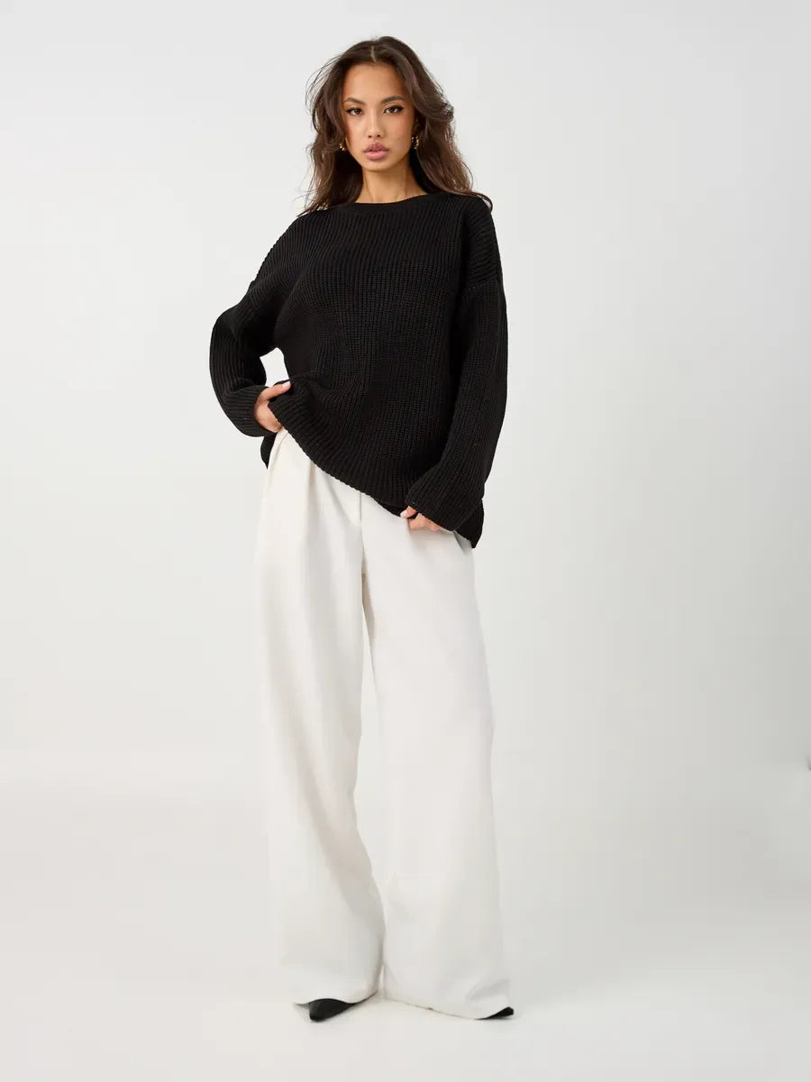 Nola Sweater by Lauven - Oversized black knit pullover with crew neck, styled with wide white trousers.