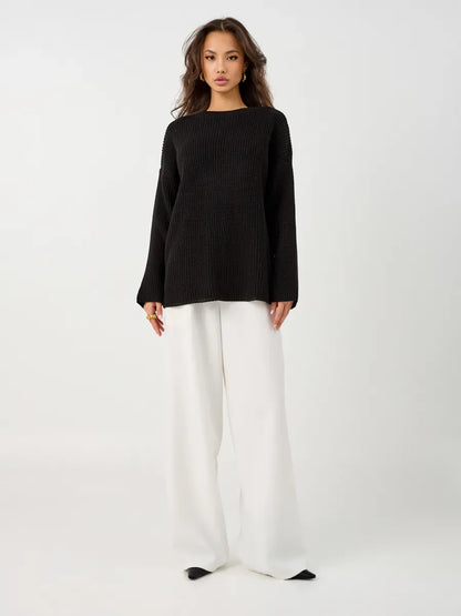 Nola Sweater by Lauven - Oversized black knit pullover paired with white wide-leg pants, showcasing a stylish look.