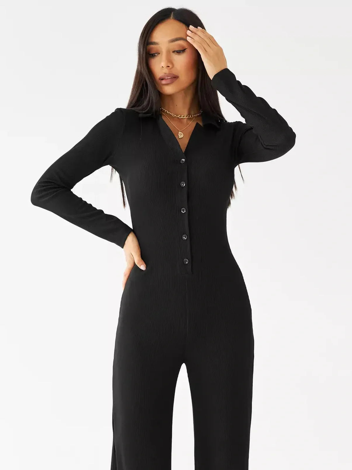 Nora Jumpsuit in black ribbed knit with button details and a classic collar, perfect for casual or formal wear.