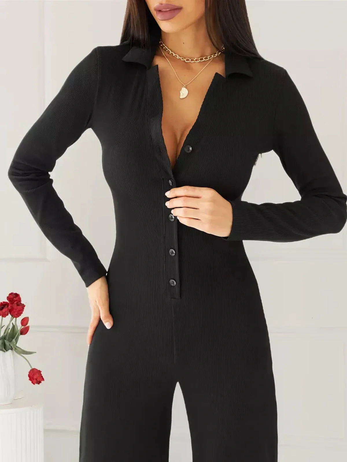 Nora Jumpsuit - Black ribbed knit jumpsuit with button details and pointed collar. Ideal for casual and formal wear.