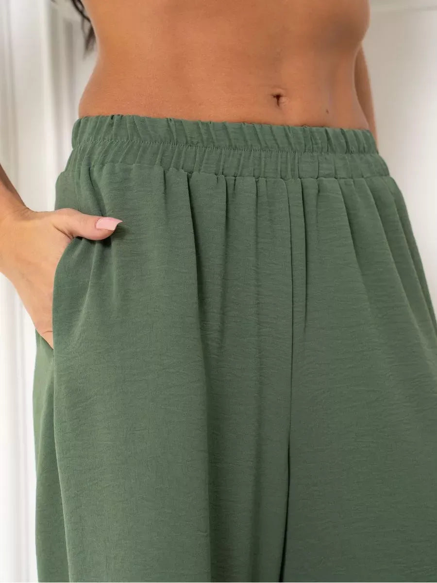 Olive Suit Set wide-leg trousers detail featuring side pockets, designed by Lauven in soft green fabric.