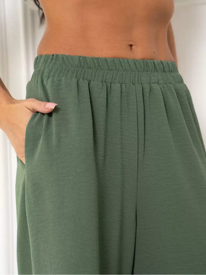 Olive Suit Set wide-leg trousers detail featuring side pockets, designed by Lauven in soft green fabric.