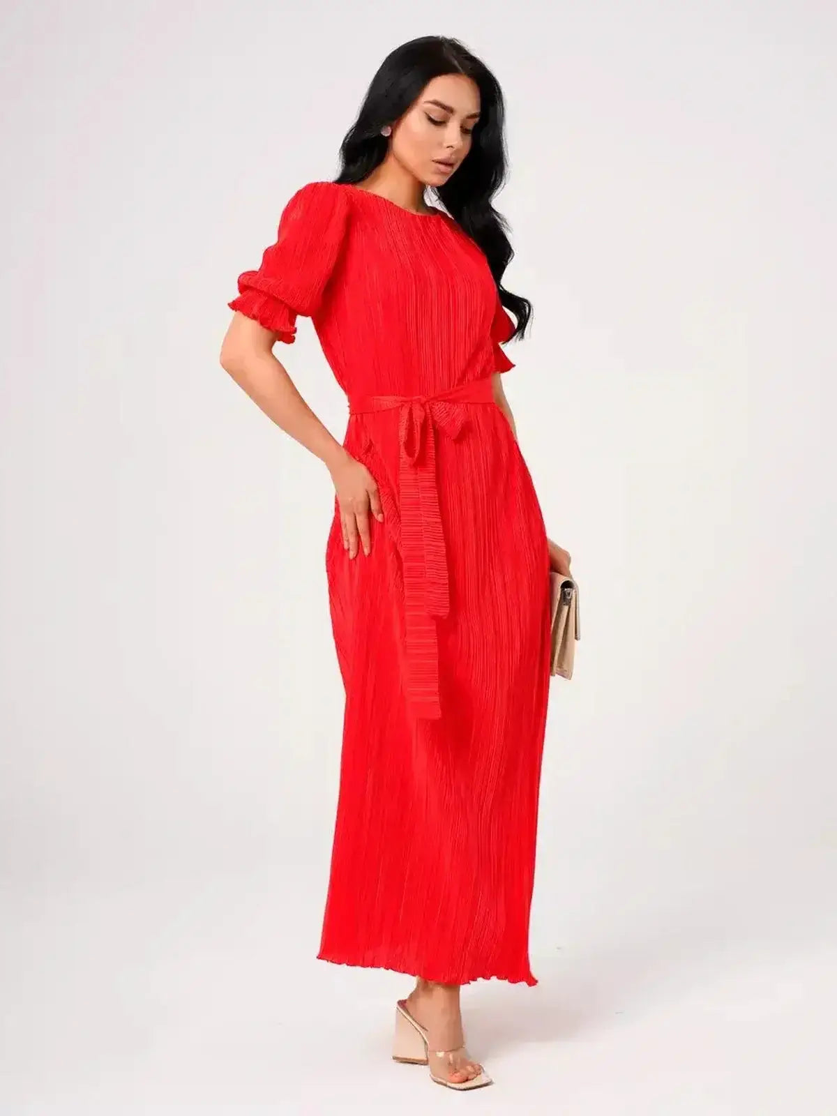 Ophelia Maxi Dress worn by a model, showcasing pleated elegance and a belted waist in vibrant red.