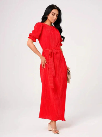 Ophelia Maxi Dress worn by a model, showcasing pleated elegance and a belted waist in vibrant red.