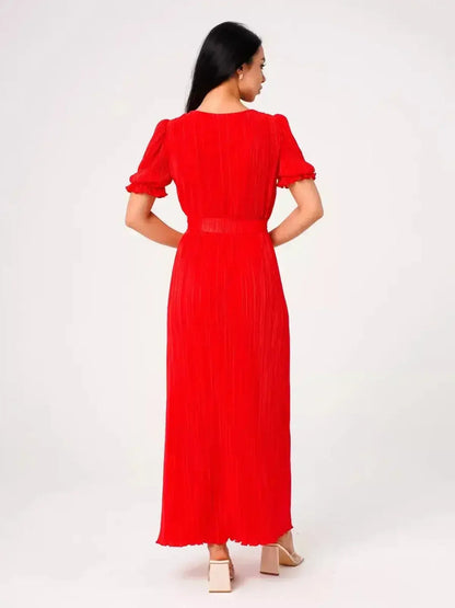 Back view of a model wearing the Ophelia Maxi Dress in vibrant red with pleats and puff sleeves.