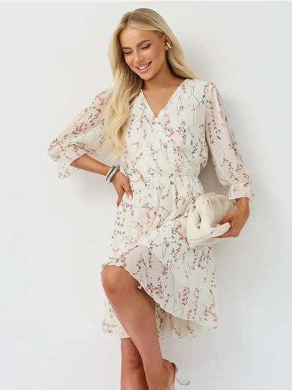 Petunia Mini Dress by Lauven, featuring a floral wrap design, V-neckline, and three-quarter sleeves with ruffles.