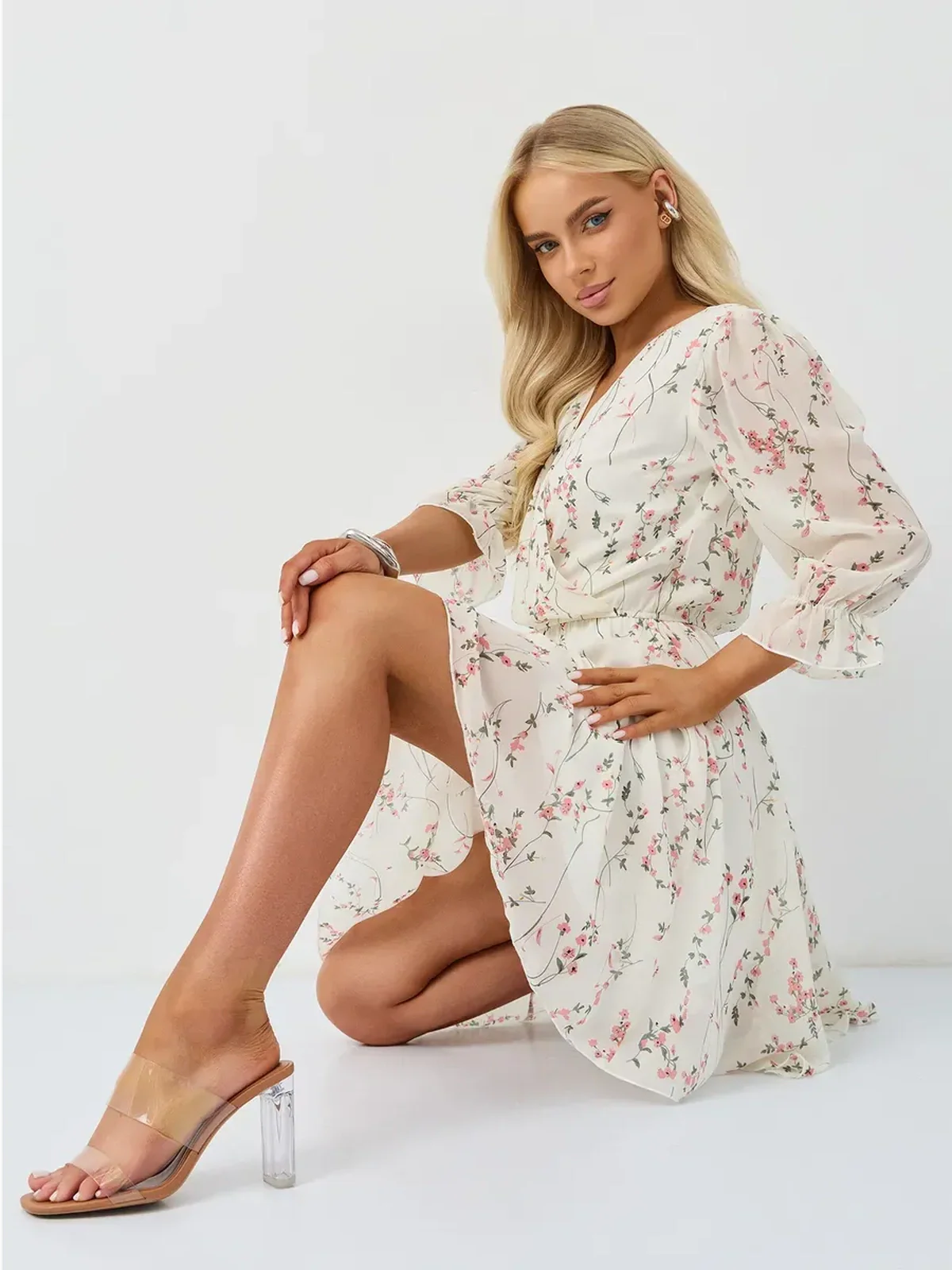 Petunia Mini Dress by Lauven, featuring a white floral print wrap style, V-neckline, and A-line silhouette.