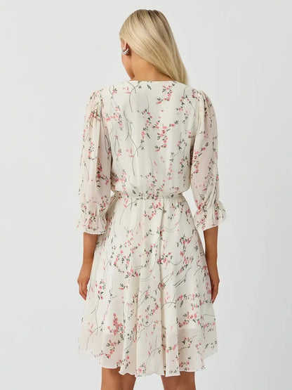 Back view of the Lauven Petunia Mini Dress showcasing its floral print and three-quarter sleeves.