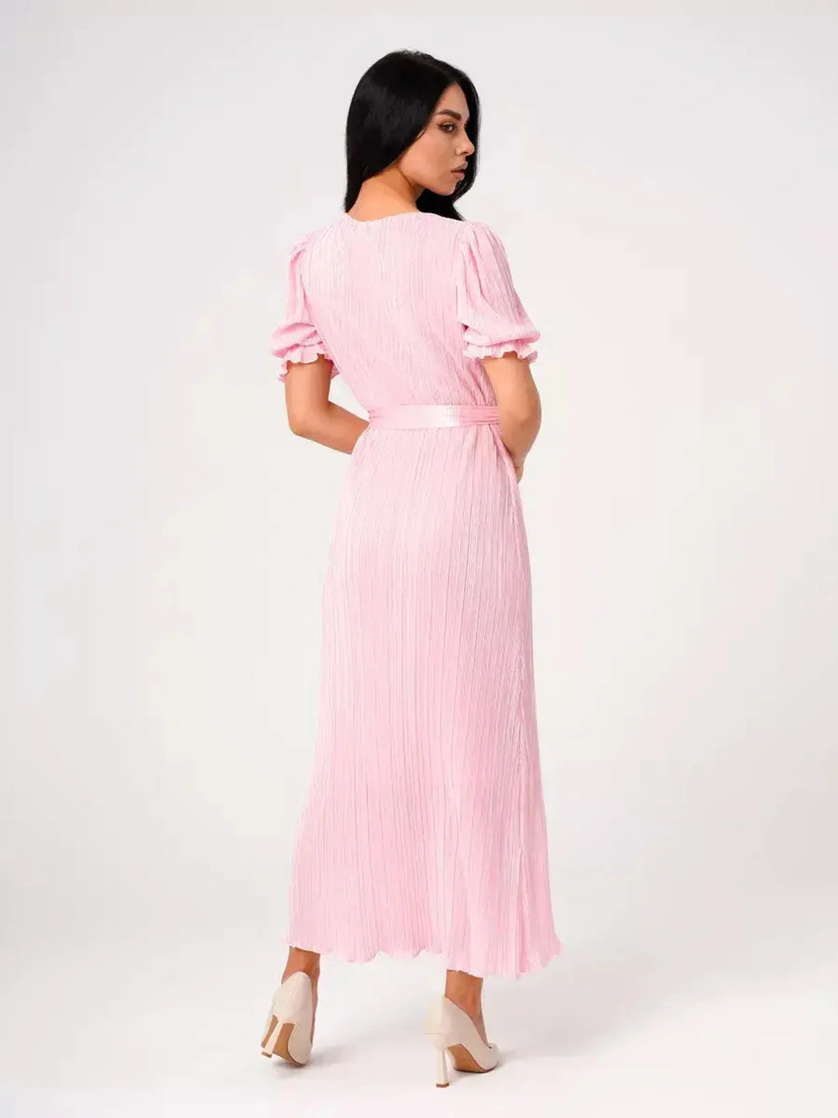 Back view of Candy Maxi Dress featuring pleated fabric, puff sleeves, and tie waist, showcasing its elegant pink design.