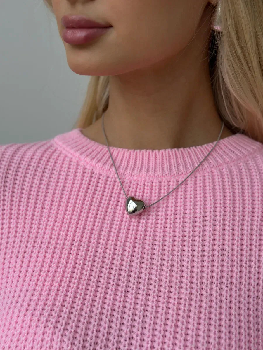 Poppy Sweater by Lauven, oversized light pink knit with crew neck, paired with a silver heart necklace.