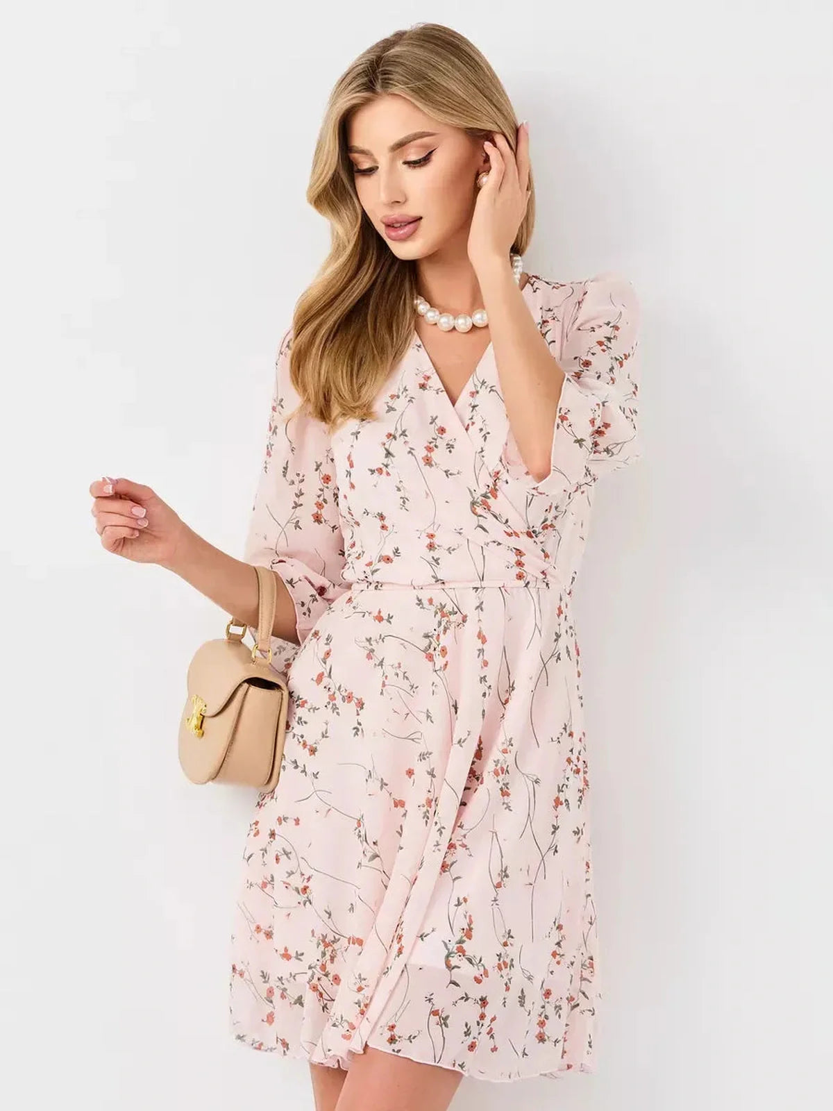Primrose Mini Dress by Lauven, pink floral wrap dress featuring a V-neckline and 3/4 puff sleeves.
