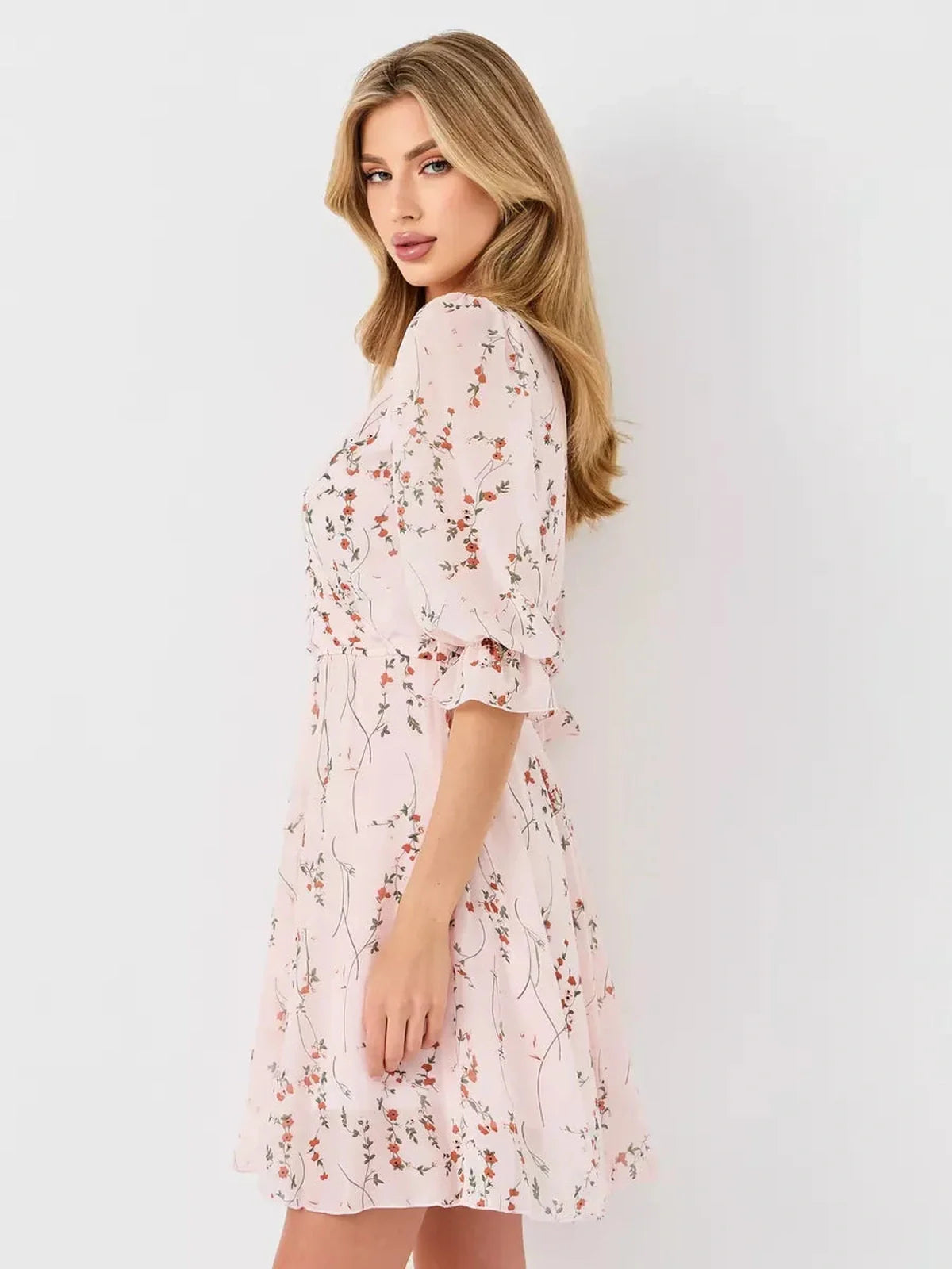 Primrose Mini Dress by Lauven, a pink floral wrap dress with A-line silhouette and 3/4 puff sleeves.