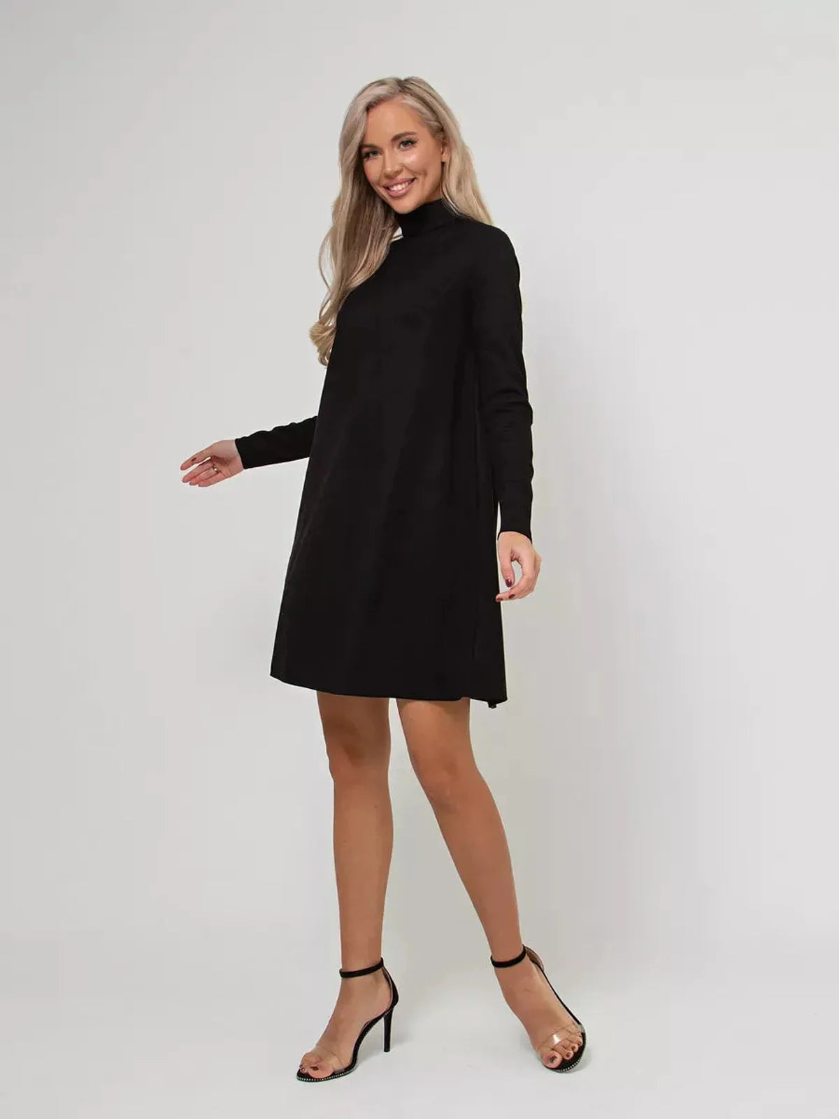Model wearing Lauven Quinn Mini Dress, a black long sleeve A-line dress with a mock neck and back zip.