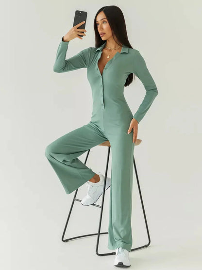 Model wearing a sage green Scarlett Jumpsuit by Lauven, showcasing its ribbed knit and wide-leg design.