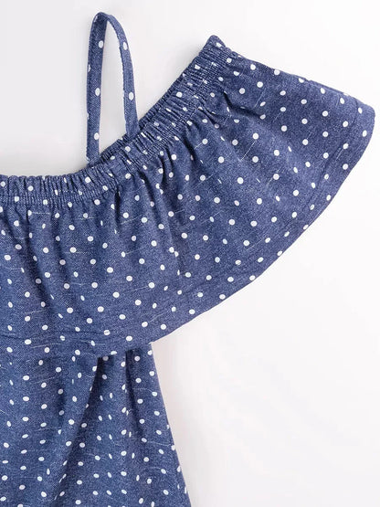 Close-up of the off-shoulder ruffle detail of the blue polka dot cotton Scarlett Mini Dress by Lauven.