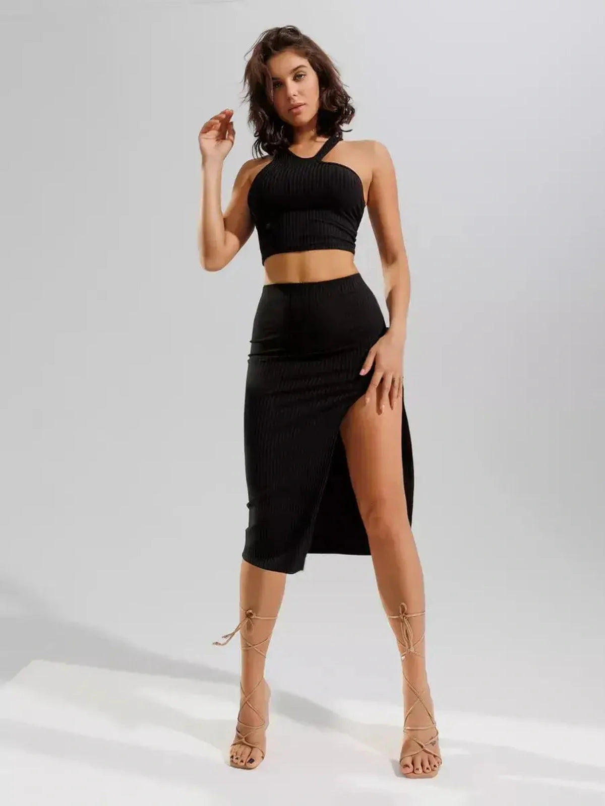 Lauven Sculpted Edge Set in black ribbed knit, featuring a one-shoulder crop top and high-waisted midi skirt.