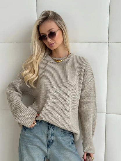 Model wearing the Sierra Sweater by Lauven, an oversized beige knit with crew neck, styled chicly.