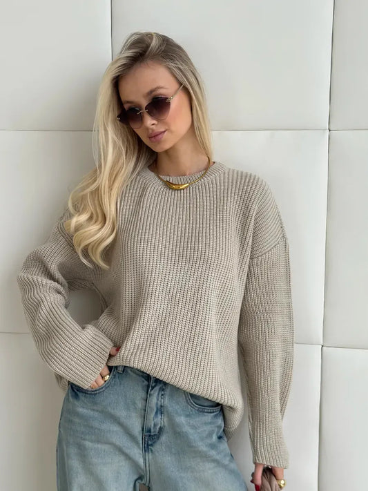 Model wearing the Sierra Sweater by Lauven, an oversized beige knit with crew neck, styled chicly.