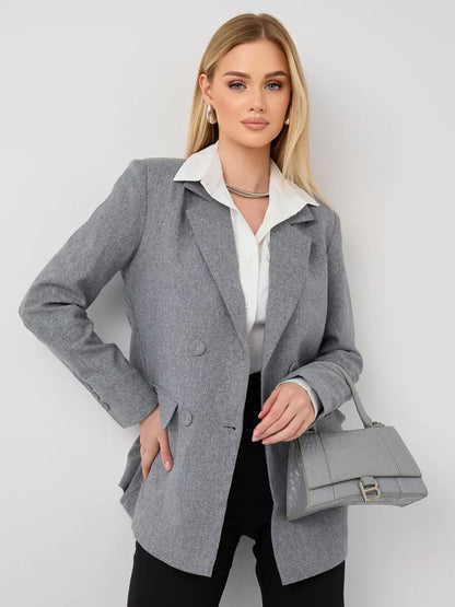 Model wearing Silverstone Blazer by Lauven, an oversized double-breasted gray tailored jacket, styled with a handbag.