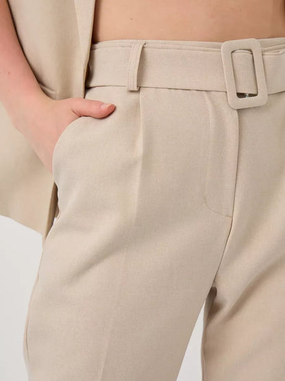 Close-up of the high-waist pants from the Solara Suit Set by Lauven, showcasing a stylish beige fabric and belt.