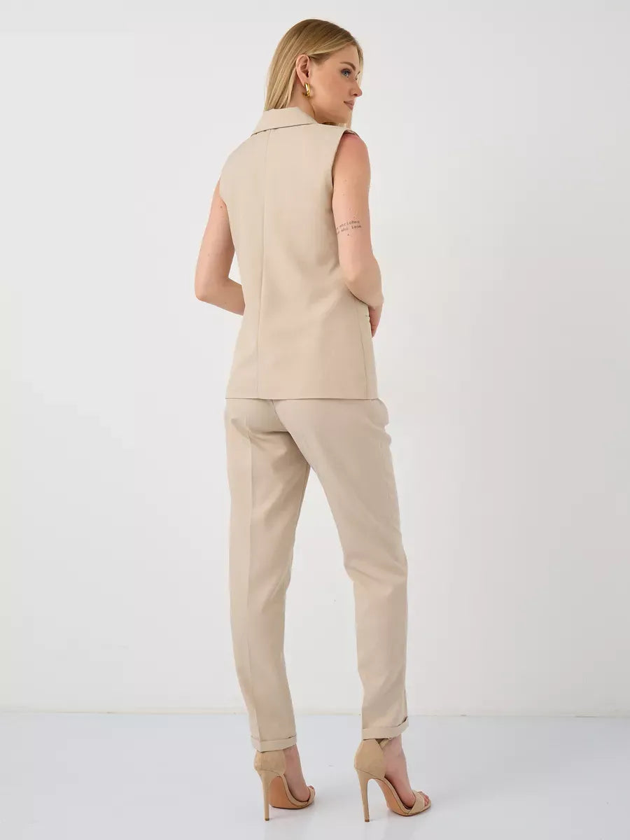 Solara Suit Set by Lauven, showcasing a sleeveless beige vest and high-waist pants from the back.