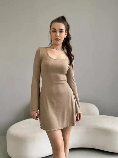 Sophia Mini Dress by Lauven in neutral ribbed knit with lace-up back and ruffled hem, showcasing feminine elegance.