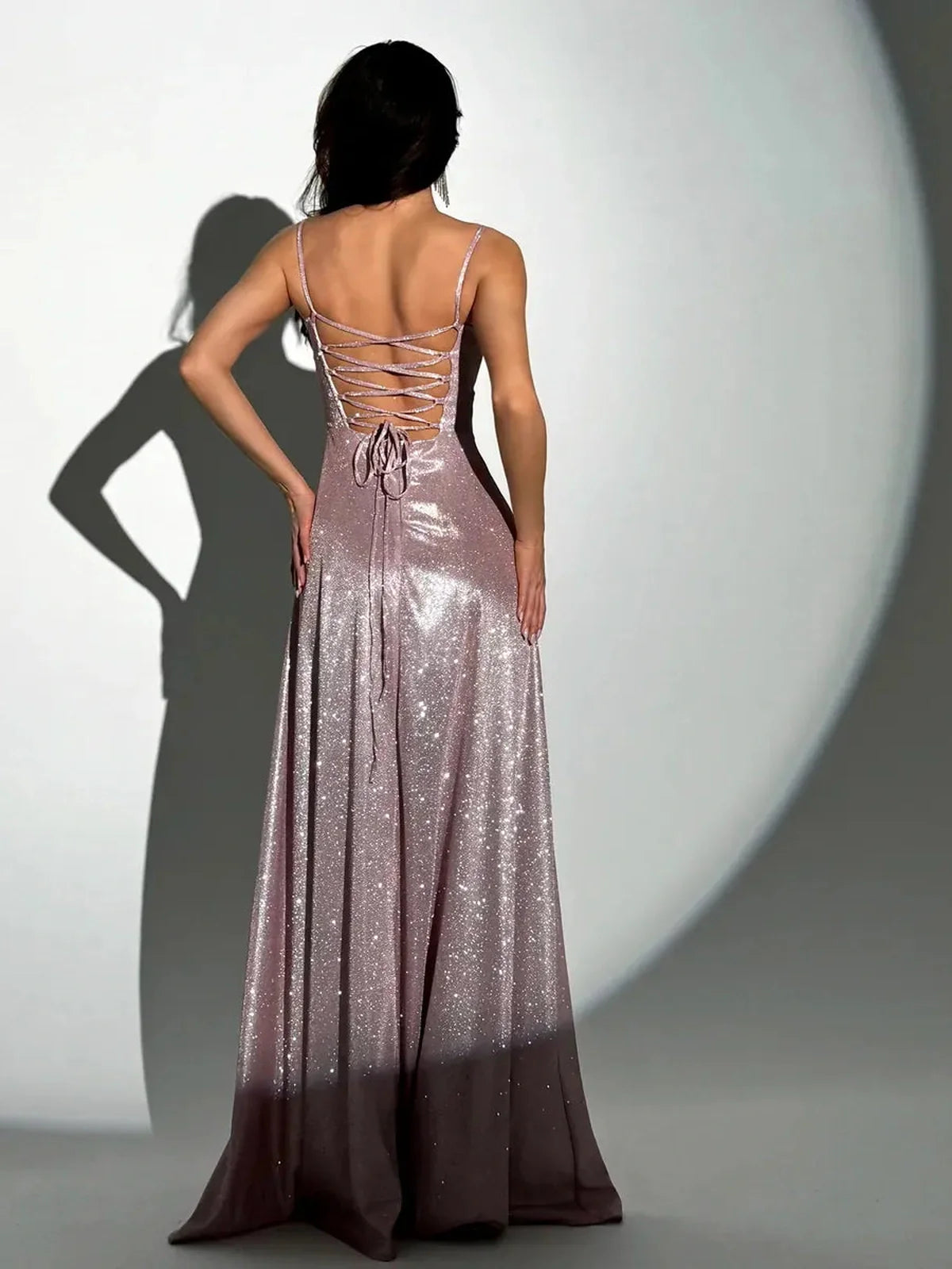 Back view of the Spell Maxi Dress by Lauven, featuring a pink glitter design and adjustable lace-up detail.