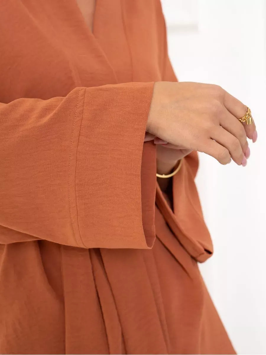 Close-up of a model's sleeve wearing the Lauven Terracotta Suit Set in warm brown, showcasing its elegant design.