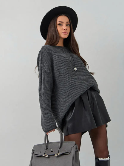 Vera Sweater by Lauven — Oversized dark gray knit pullover paired with a stylish black skirt and hat.