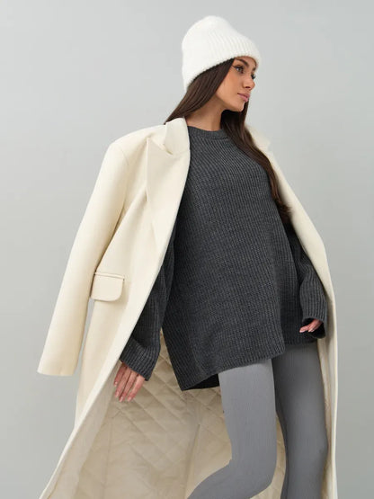 Vera Sweater by Lauven, oversized dark gray knit pullover worn with a chic coat and hat, perfect for cold seasons.