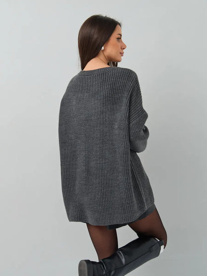 Back view of a woman wearing the Vera Sweater by Lauven in oversized dark gray knit.