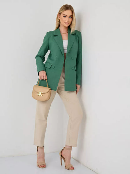 Verde Blazer by Lauven, an oversized double-breasted green tailored jacket, worn with beige pants.