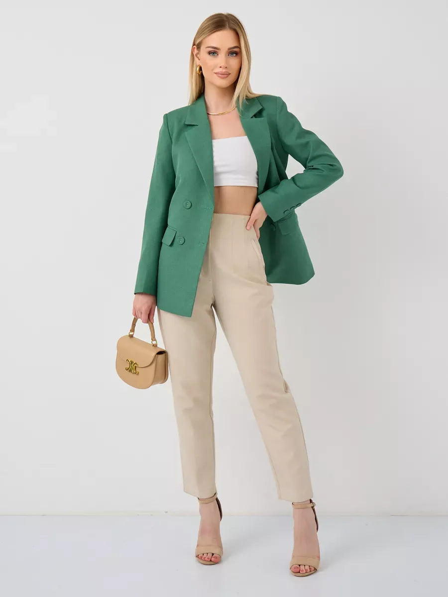 Model wearing Verde Blazer by Lauven, an oversized green tailored jacket paired with beige pants.