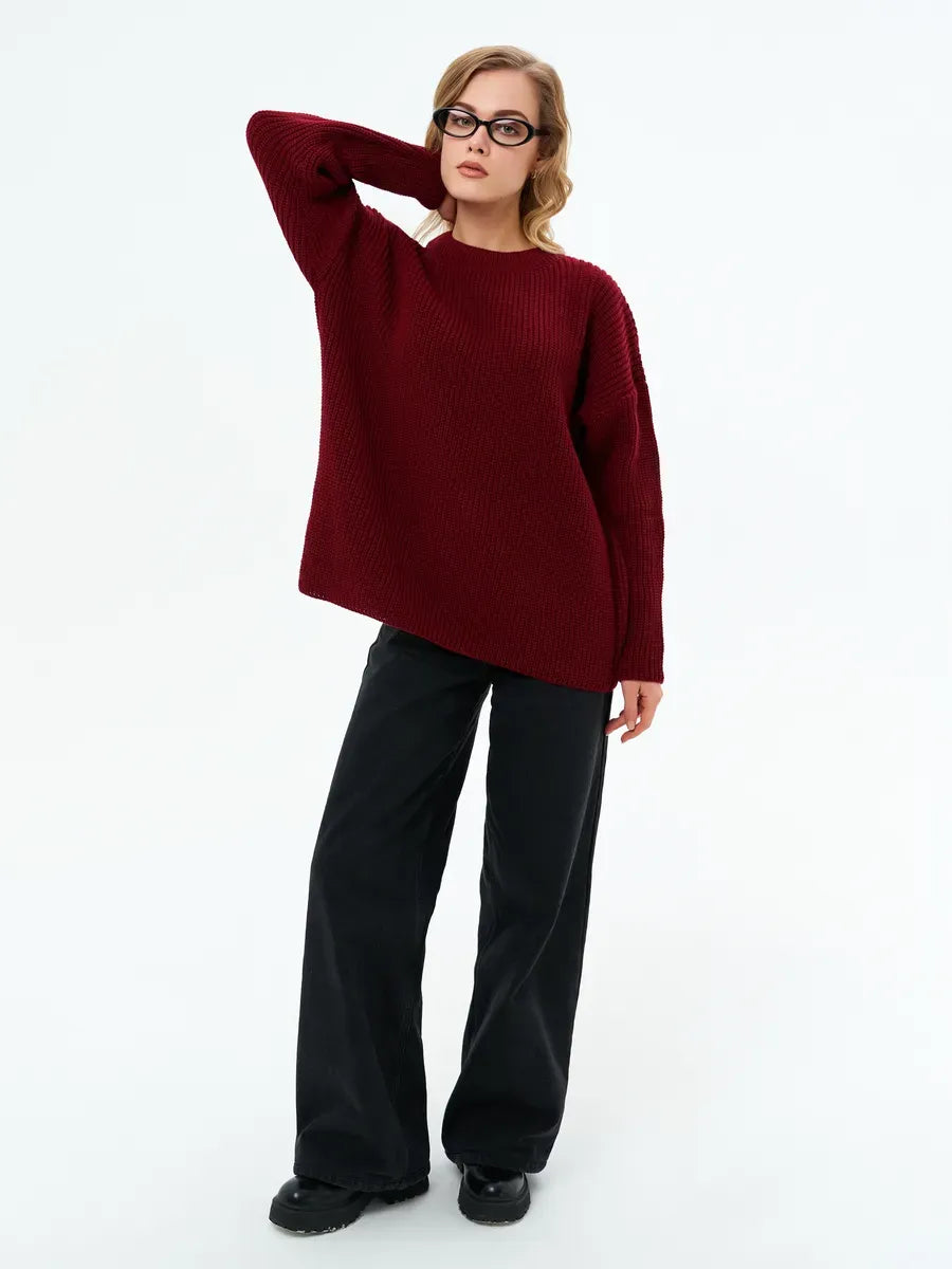 A model wearing the Verona Sweater by Lauven in deep burgundy, demonstrating oversized knit style and relaxed fit.