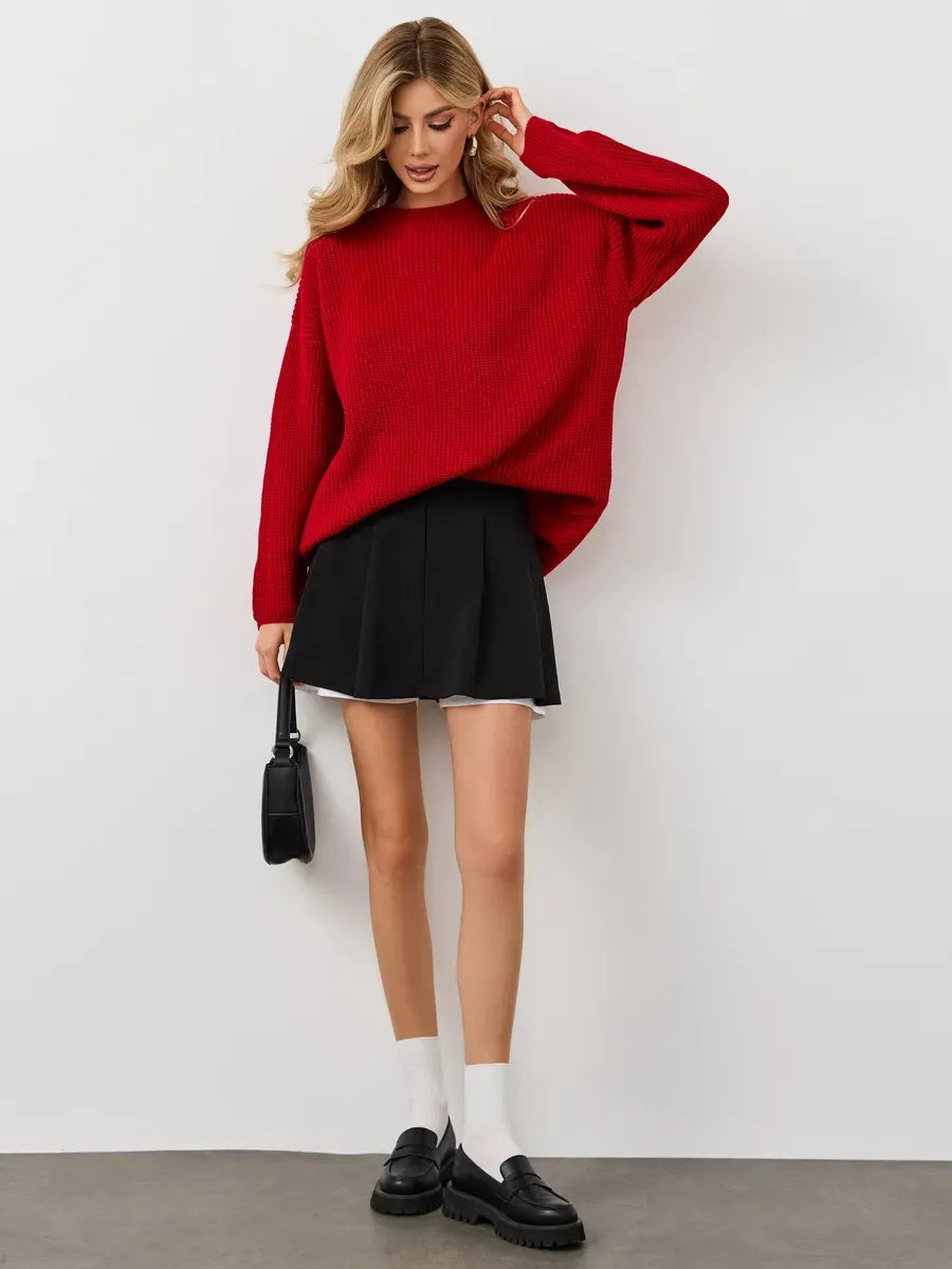 Viona Sweater by Lauven, oversized red knit pullover with crew neck, styled with a black skirt.