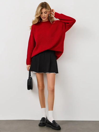 Viona Sweater by Lauven, oversized red knit pullover with crew neck, styled with a black skirt.