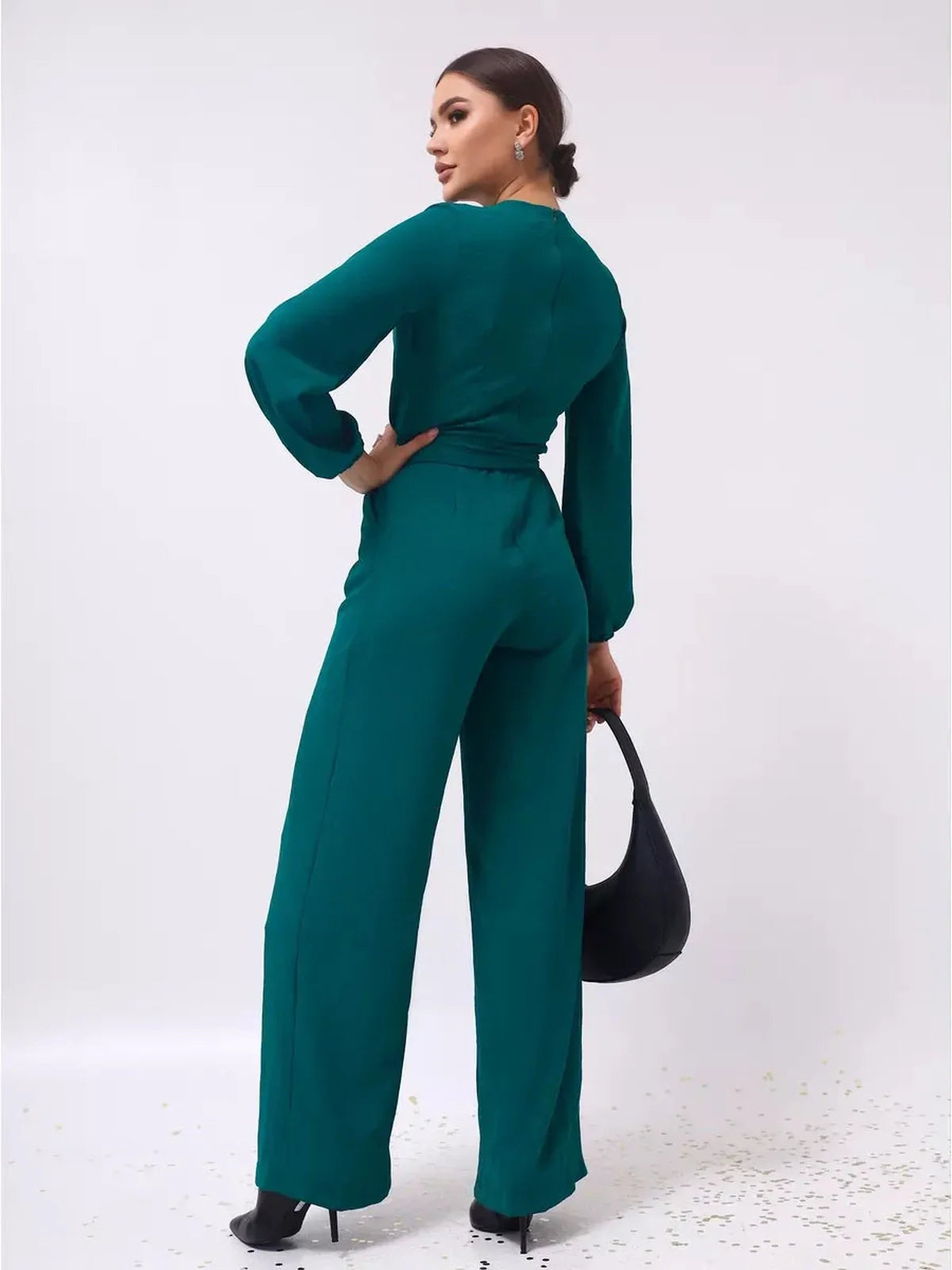 Zoe Jumpsuit in teal color, featuring wide-leg trousers and a self-tie belt, back view with long sleeves.
